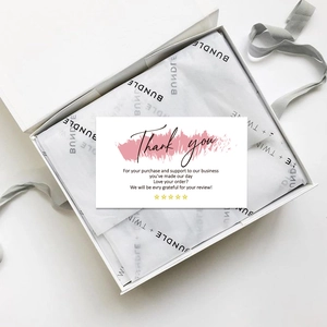 Flat lay of colorful Thank You cards with elegant gift box, gray ribbon and tissue paper