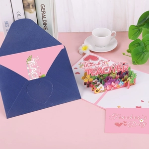 3D Teacher's Day pop-up greeting card with flowers and envelope on a desk
