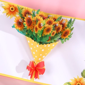 Handmade 3D pop-up greeting card featuring a vibrant sunflower bouquet and red bow