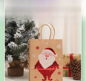 Close-up of brown kraft paper gift bag with red Santa Claus and white snowflakes patterns
