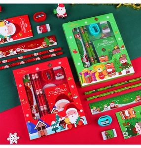 Close-up of Christmas stationery set with pencil, ruler, eraser and notebook in gift box