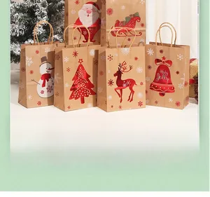 Detail of kraft paper Christmas gift bags with gold stamping and red twine handles