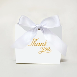 Elegant white wedding favor box with gold Thank You script and satin ribbon bow