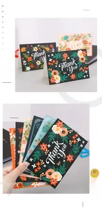 Macro detail of floral thank you card featuring premium white paper and gold gilding