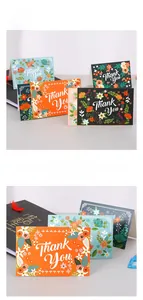 Detailed view of floral Thank You cards with colorful botanical patterns and white lettering