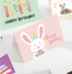 Detail of pink cartoon Happy Birthday card featuring a cute rabbit and cake with envelope