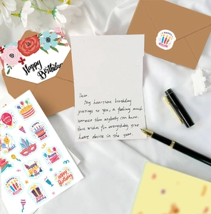 Detail of floral Happy Birthday card set with kraft envelopes and stickers on silk