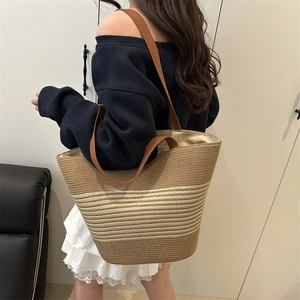 Large woven tote bag with brown stripes and shoulder strap for beach and daily commute