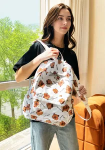 Detailed close-up of a white backpack featuring a cute cartoon Capybara print and straps