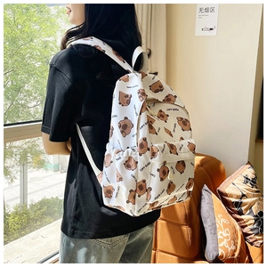 Detailed close-up of cute brown capybara print on white canvas backpack for girls