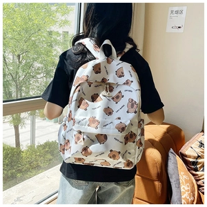 Detail of white backpack with brown Capybara animal prints and durable zipper pockets