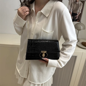Chic black crocodile embossed underarm bag with gold chain strap and T-lock closure