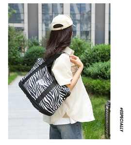 Outdoor shot of a zebra print travel tote bag with large capacity and durable handles