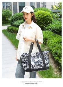 Outdoor shot of zebra print travel bag showing large capacity and bottom zipper layer