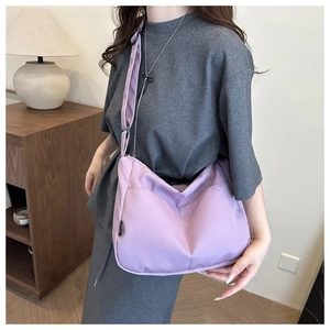 Detailed view of the purple nylon tote bag showing soft fabric texture and adjustable strap