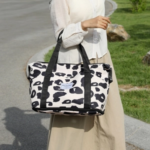 Large cow print tote bag with bottom zipper compartment for travel and daily leisure