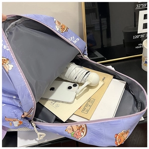 Interior view showing the large capacity of a purple capybara backpack with student supplies