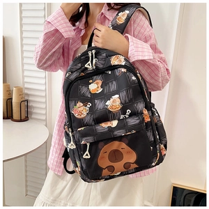 Detail of black backpack featuring cute capybara eating ramen patterns and nylon texture