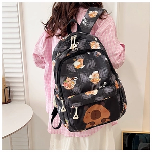Rear view of a black backpack featuring cute capybara prints and white mesh pattern