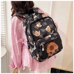Detail showing the cute capybara print and high capacity design of the black school backpack