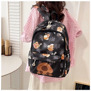Rear view of model wearing a black capybara backpack with cartoon prints and side pockets