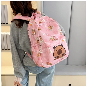 Pink large capacity backpack featuring cute cartoon Capybara prints shown on a model