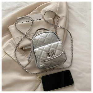 Detail of silver quilted leather mini backpack with chain strap and metallic finish