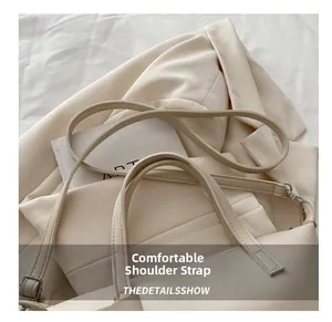 Close-up of comfortable double shoulder straps on a beige leather bucket bag