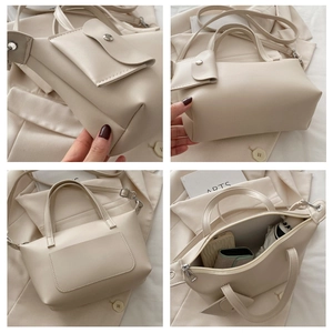 Detail of minimalist apricot bucket bag with detachable strap and small square pendant