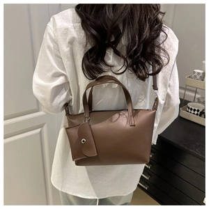 Detailed back view of a brown trapezoid bucket bag with a matching small coin purse