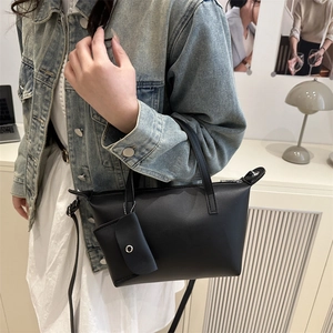 Black vintage tote bag with small pouch charm and silver chain detail for women