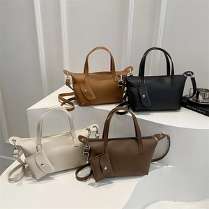 Retro large-capacity PU leather bucket bags in four colors on a white geometric stand