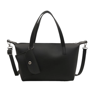 Retro black faux leather bucket tote bag with matching chain pouch on white background