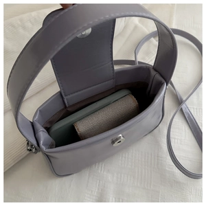 Macro shot of lavender purple crossbody bag showing inner storage for phone and cards