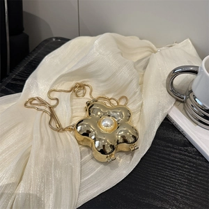 Elegant gold flower shaped evening clutch bag with pearl center and snake chain strap