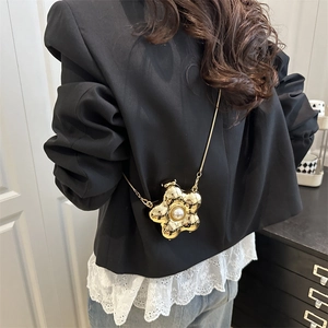 Golden flower-shaped mini crossbody bag with pearl center and metal chain strap