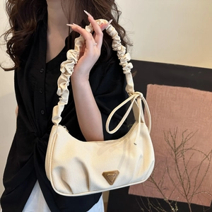 Chic beige pleated canvas shoulder bag with wave texture and elegant bow strap detail