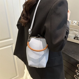 Light blue denim doctor bag with metal frame and brown woven handle for women
