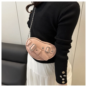 Detail of pink glossy patent leather crossbody bag with silver chain and rivet buckle