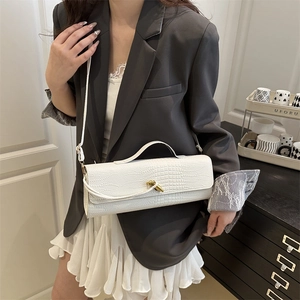 Modern white crocodile pattern rectangular shoulder bag with golden twist lock on model
