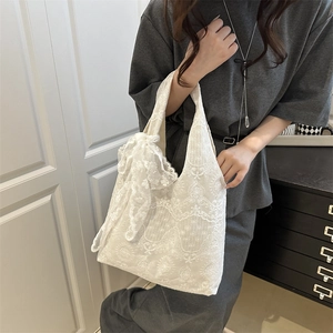 Elegant white lace shoulder bag with a vintage floral embroidery and oversized bow detail