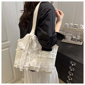 Détail du sac cabas en dentelle blanc crème avec couches florales et grand nœud