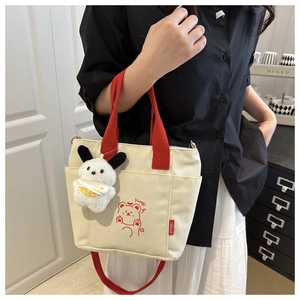 Contrast canvas tote bag featuring red bear print and cute plush dog charm detail