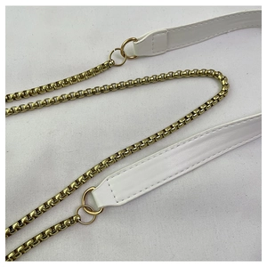 Close-up of white leather shoulder strap with gold chain links and neat stitching details