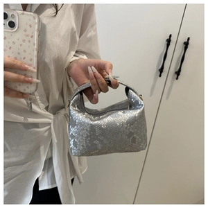 Detail of silver snake-embossed hobo bag with metallic texture and zipper closure
