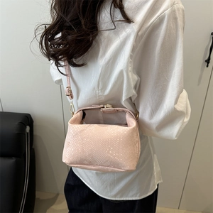 Pink snakeskin pattern crossbody pillow bag with gold hardware and trapezoid structure