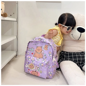 Purple school backpack with cartoon bears shown on a young model next to a plush bear