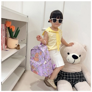 Detailed view of purple backpack with cartoon bear prints and functional side mesh pocket