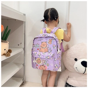 Rear view of child wearing purple cartoon bear backpack with side triangle ornament