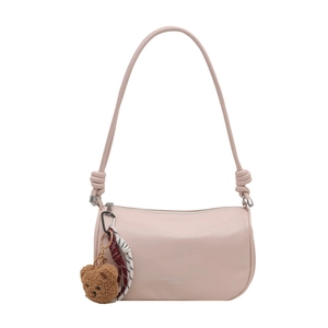 Pink cylinder pillow bag with plush bear charm and knotted straps on white background